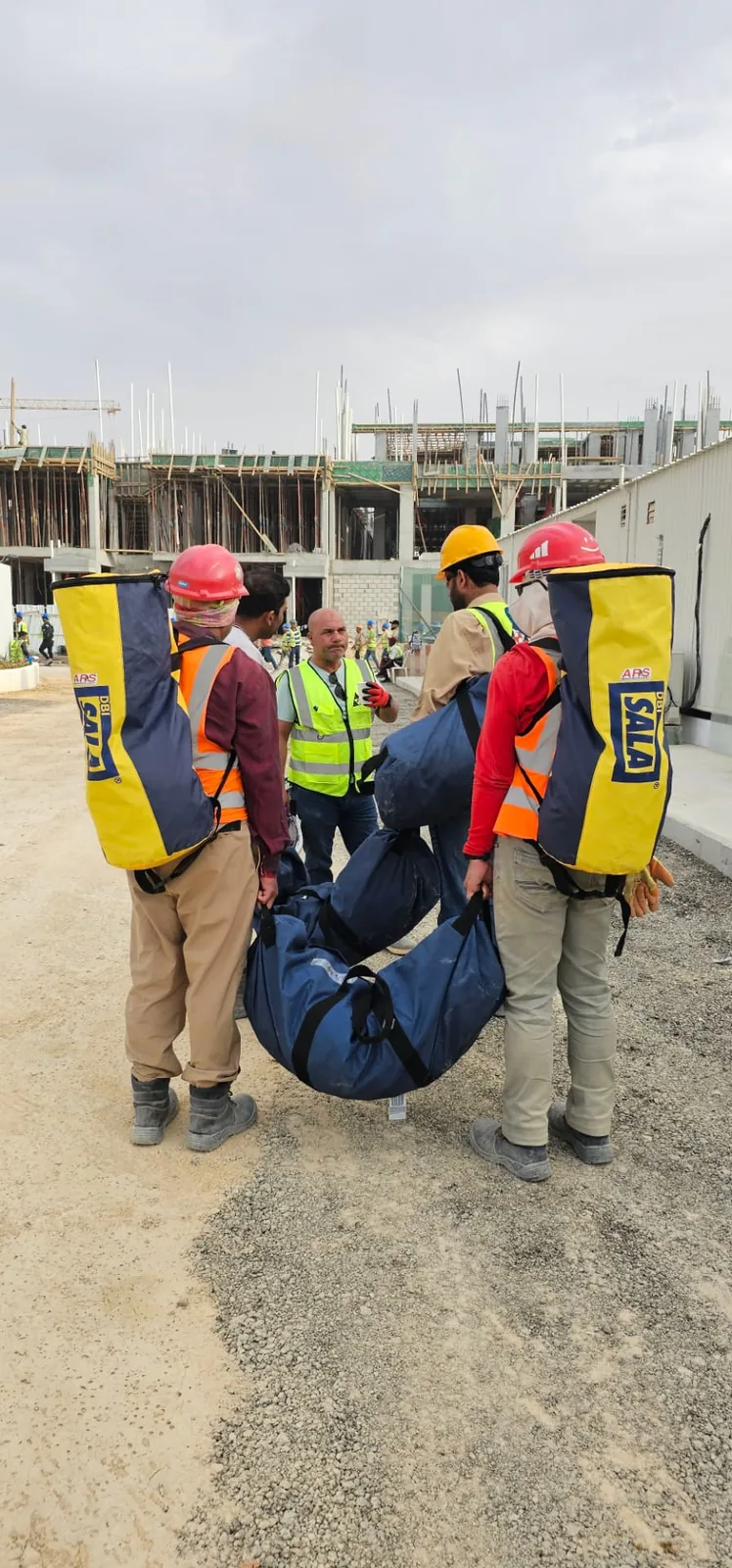 ARS crew moving a rescue litter across an active industrial site