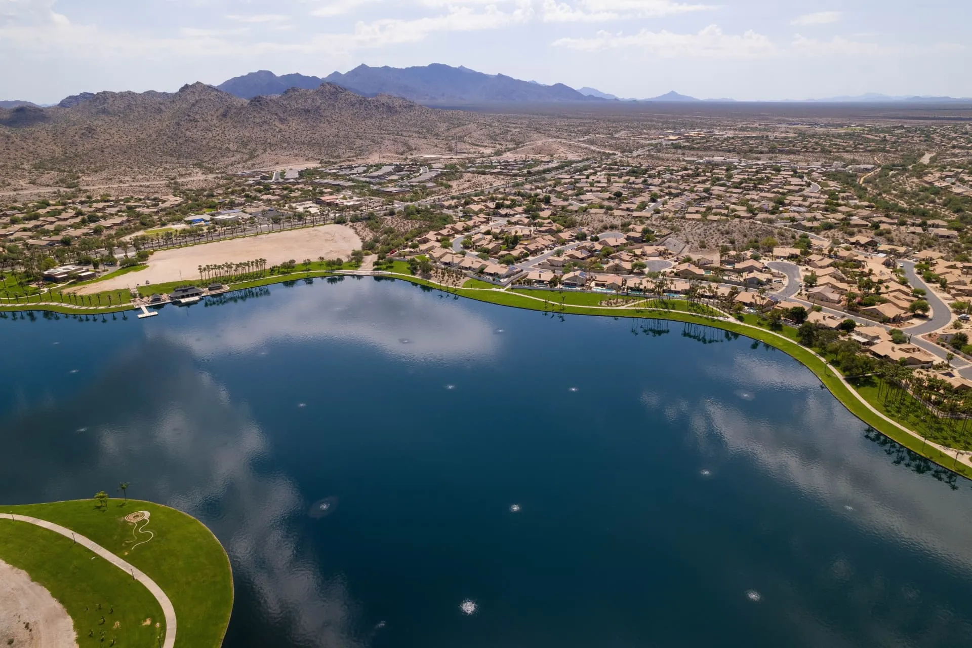 Aerial view of a Goodyear community lake with the Estrella Mountains behind, rope access, confined space rescue and safety services in Goodyear, AZ