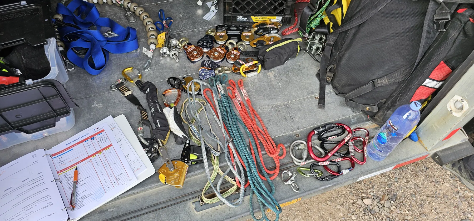Rope, retrieval hardware and job paperwork staged before a confined-space entry