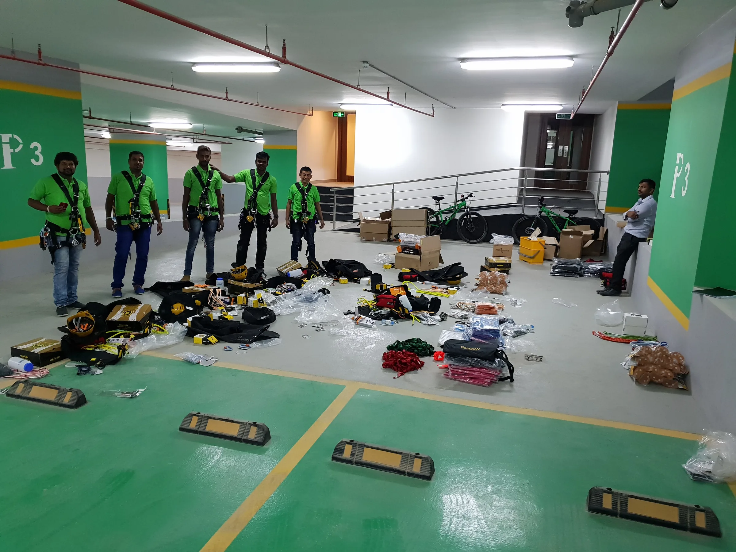 Crew members organizing rope-access equipment and hardware before work