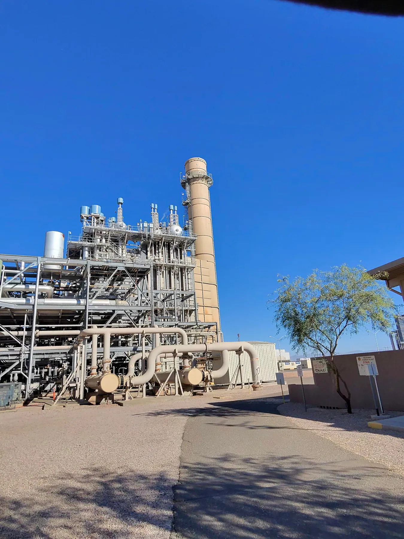 Exterior of an industrial process plant with stack and structural framework