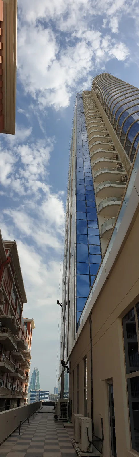 ARS rope access technician descending a high-rise facade on rope