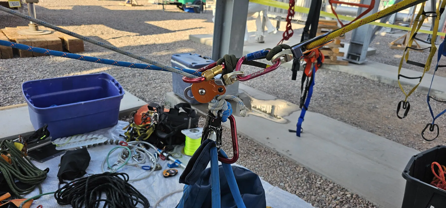 Rope bags, hardware and anchor plates staged on site before rigging begins