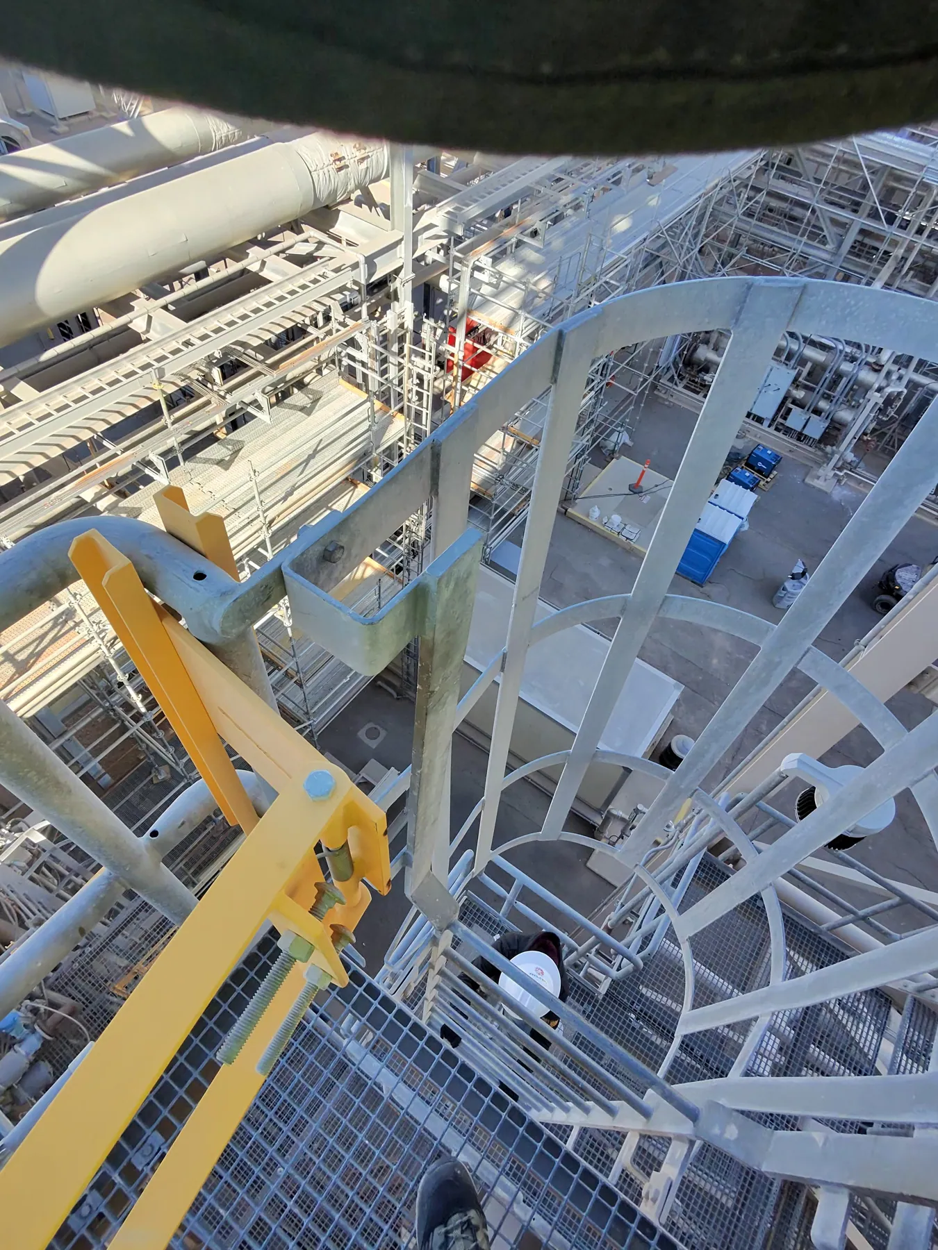 Elevated steel walkway and grating above industrial process equipment