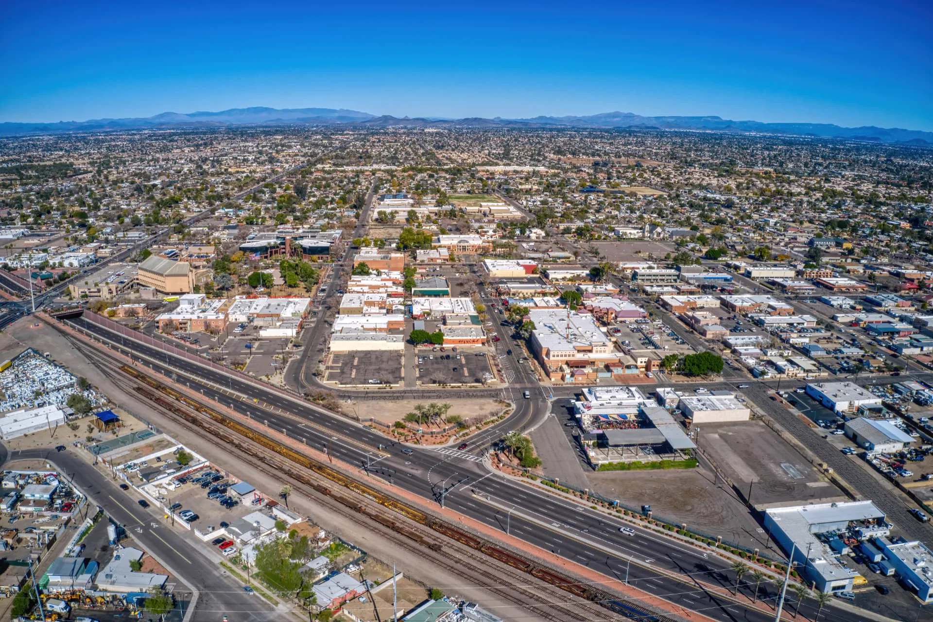 Aerial view of downtown Glendale with the rail corridor and commercial buildings