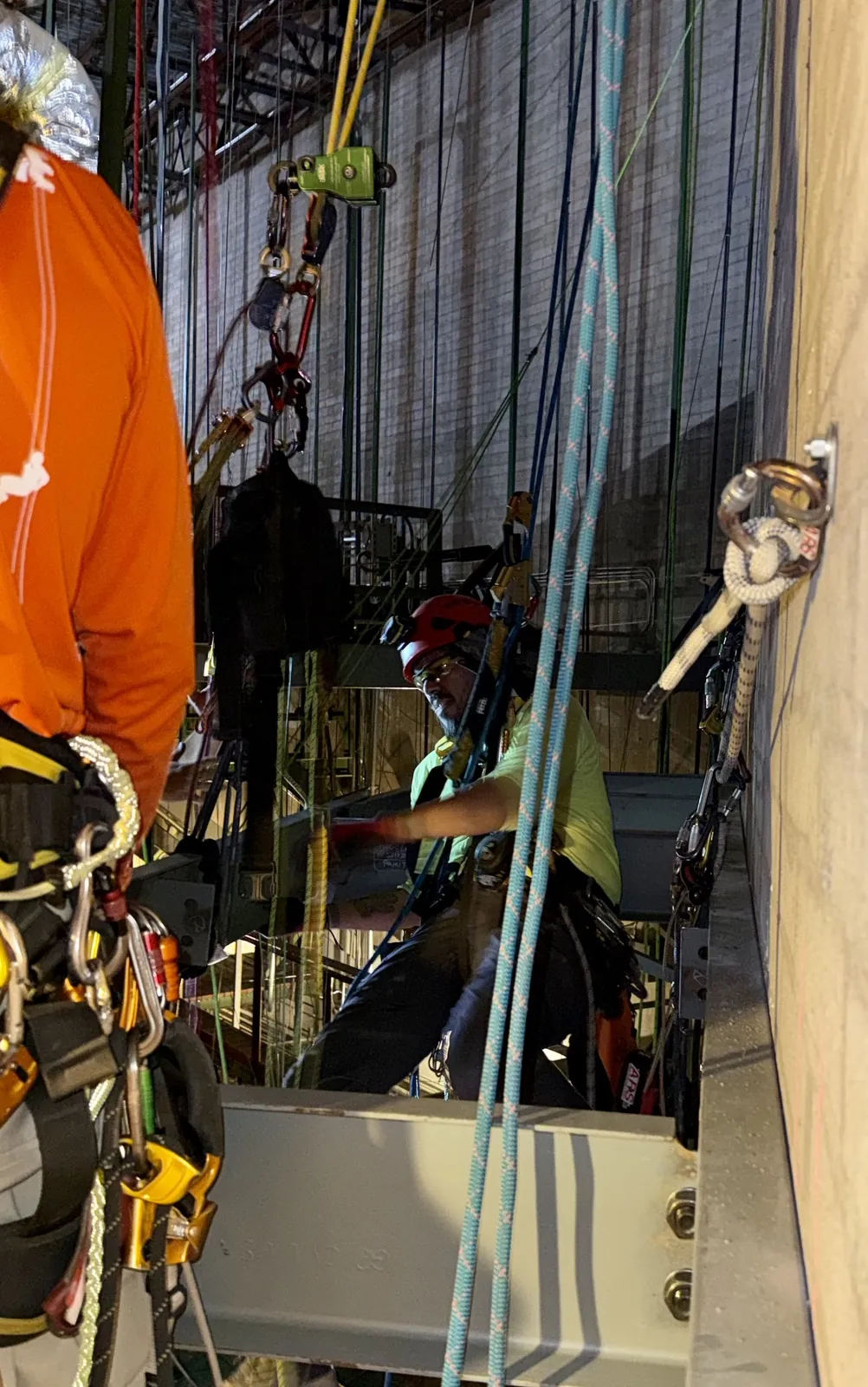 Two ARS technicians coordinating rope access work on an industrial steel install