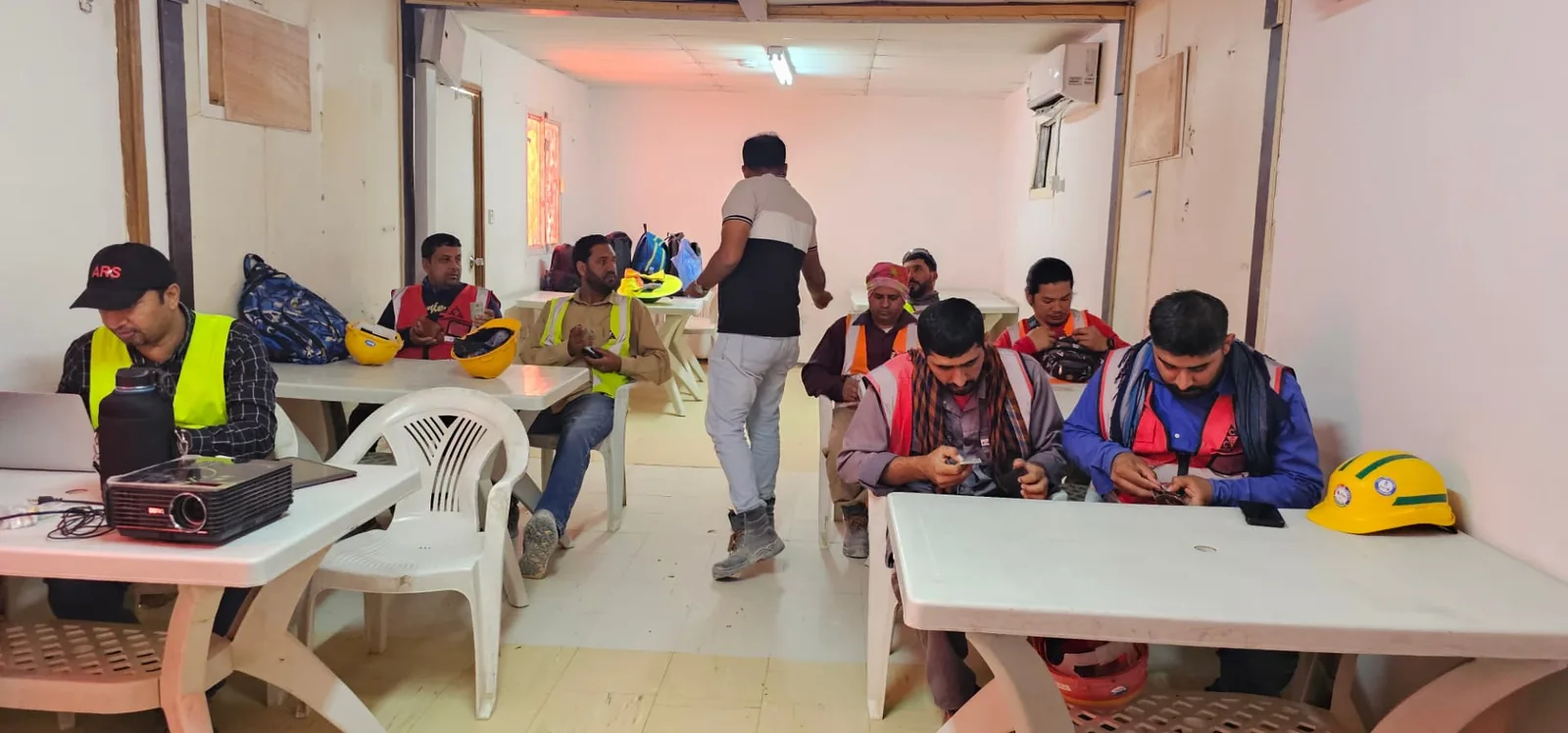ARS instructor leading a site safety and rescue training briefing with a seated crew