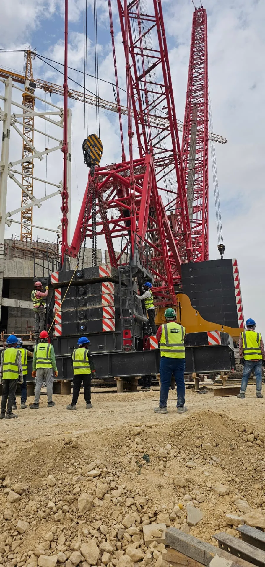 ARS crew coordinating work alongside crane assembly on an industrial site