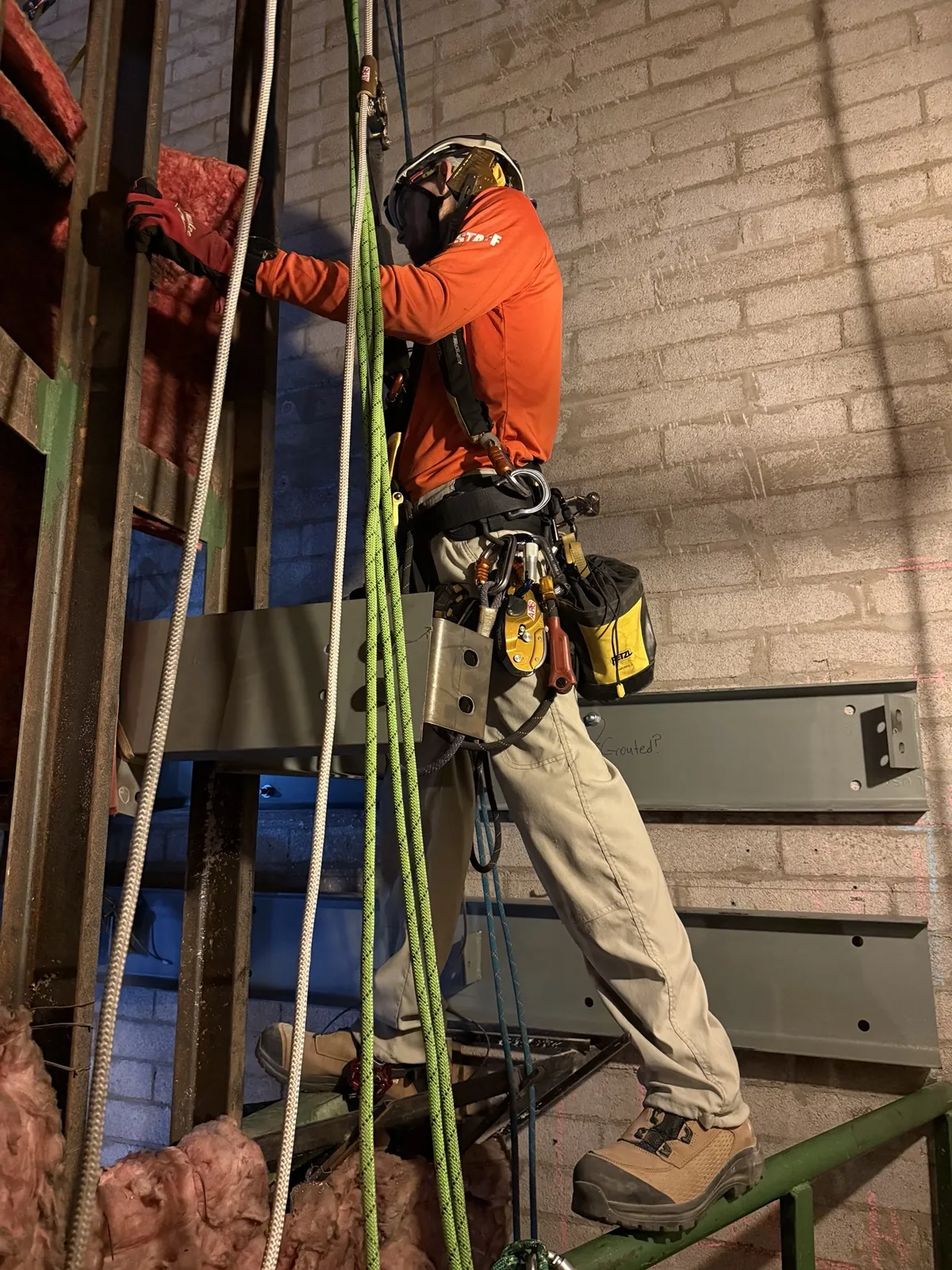 ARS rope access technician installing steel on a live industrial project